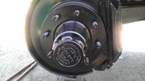 1989 Ford Bronco - Close-up view of a vehicle's wheel hub and brake assembly, painted black.