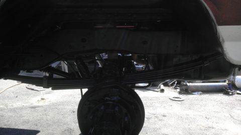 1989 Ford Bronco - Close-up of a vehicle's rear axle and suspension system, showing leaf springs and shocks.