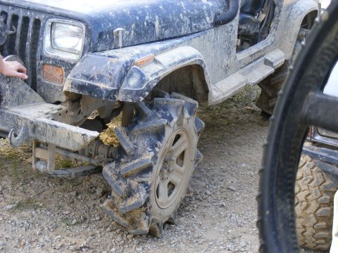 1978 Ford Bronco - This heavily modified Jeep Wrangler YJ is covered in mud, its aggressive off-road tires.