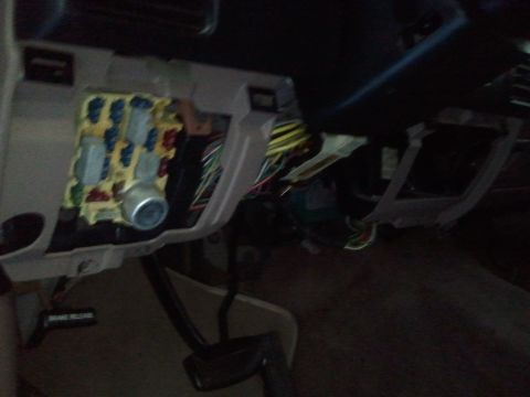 1994 Ford Bronco - Interior view of a vehicle's fuse box and wiring harness.