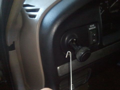 1994 Ford Bronco - Close-up of the 1994 Ford Bronco's dashboard, showing the ignition and rear window controls.