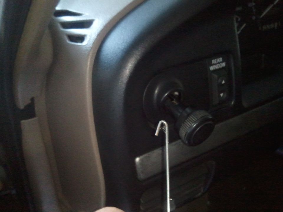 1994 Ford Bronco interior dashboard with ignition cylinder and a rear window switch
