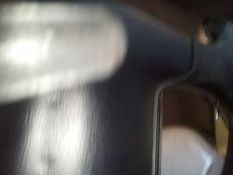 1994 Ford Bronco - A close-up view of the interior dashboard reveals dark trim and a reflective element, with a watermark at the bottom.