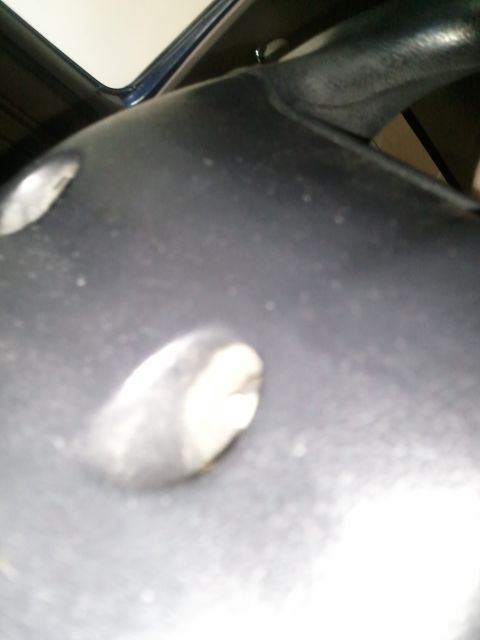 1994 Ford Bronco - Detail of a steering wheel column cover, likely from a vehicle's interior.