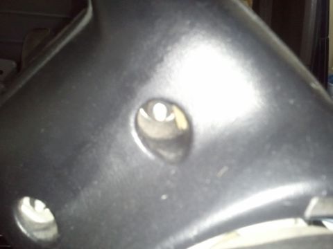 1994 Ford Bronco - Close-up of a vehicle's steering column shroud, showing two circular openings and a portion of the Supermotors.net watermark.