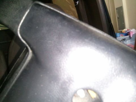 1994 Ford Bronco - Close-up view of the steering column shroud, showing its textured surface and seam detail.