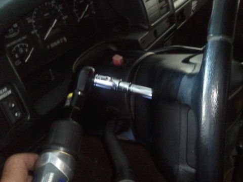 1994 Ford Bronco - A 1994 Ford Bronco's interior is visible, with a drill and socket wrench near the steering column.