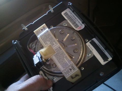 1994 Ford Bronco - This part appears to be a clock spring, likely from a vehicle's steering wheel, with various warning labels and Ford part numbers visible.