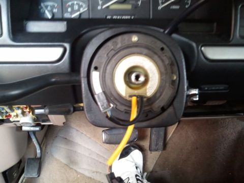 1994 Ford Bronco - The clock spring assembly is visible in the interior of a 1994 Ford Bronco, with a yellow wire protruding.