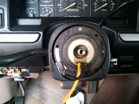 1994 Ford Bronco - Clock spring assembly removed from steering column, showing wiring and part of the dashboard.