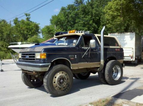 1995 Ford Bronco - This heavily modified Ford Bronco features dual rear wheels and an extended exhaust pipe.