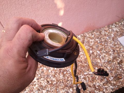 1994 Ford Bronco - A car part, identified by the label TA-14A664-BE, is held in a hand.