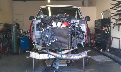 1992 Ford Ranger - Workshop scene shows a truck's front end completely dismantled for repair or modification.
