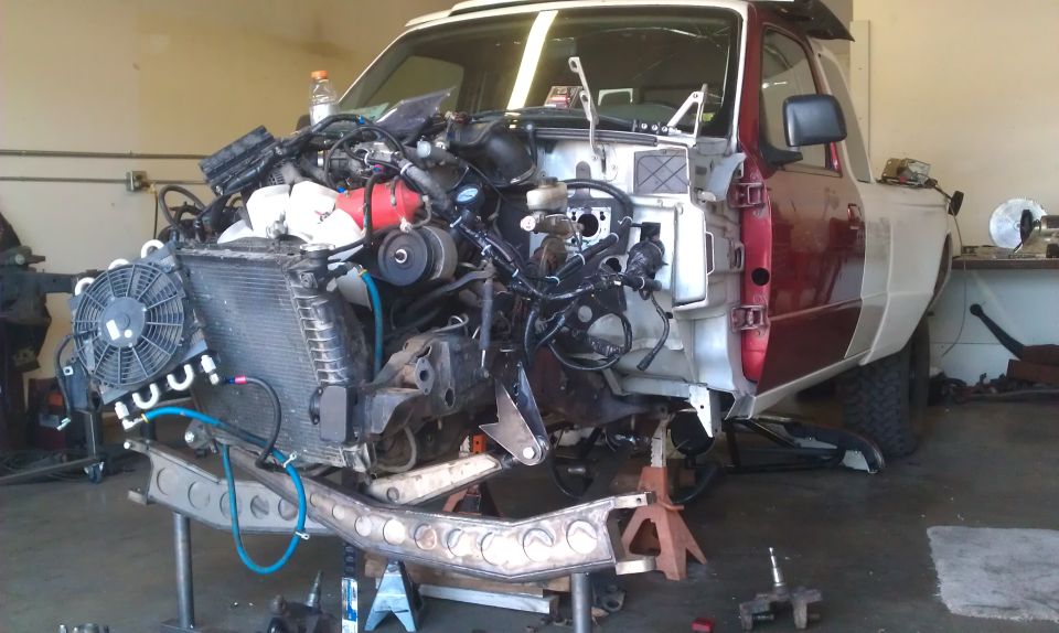 1992 Ford Ranger with engine and front clip removed, on jack stands in a workshop