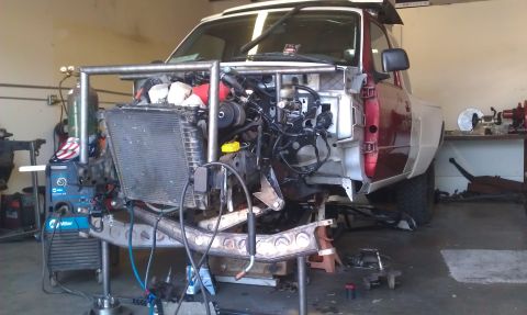1992 Ford Ranger - This truck is in a workshop, with its front end disassembled for modifications and custom fabrication.