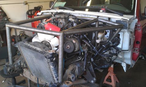 1992 Ford Ranger - Custom roll cage installed in the engine bay of a 1992 Ford Ranger, a modified intake system.