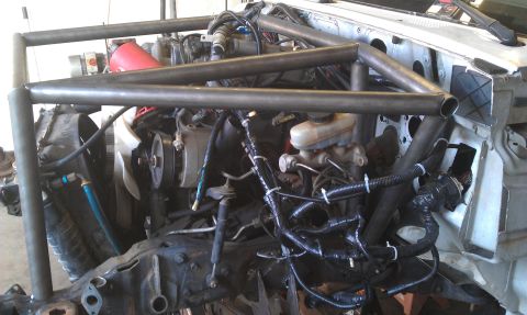 1992 Ford Ranger - Custom roll cage fabrication in progress within an engine bay.