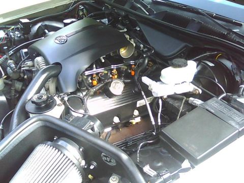 2000 Mercury Grand Marquis - The engine bay of a vehicle, showing various components and wiring.