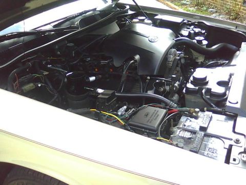 2000 Mercury Grand Marquis - The engine compartment of a car is shown with various components and wiring.
