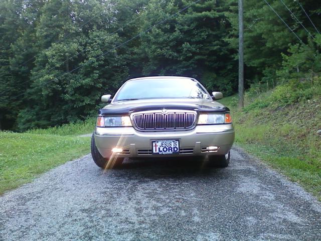 Front view of gold Mercury Grand Marquis with JESUS IS LORD plate