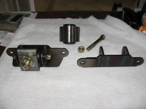 1995 Ford Bronco - Several motor mounts and associated hardware are displayed on a white towel, likely for automotive repair or upgrade.