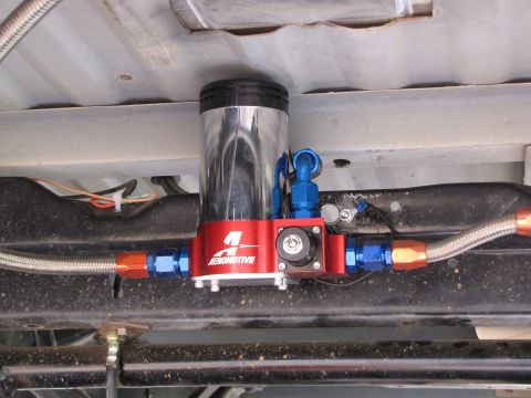 1995 Ford Bronco - An aftermarket Aeromotive fuel pump assembly is installed on the undercarriage of a vehicle.