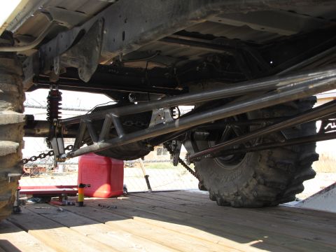 1995 Ford Bronco - Custom rear suspension components and large tires are visible on a trailer.