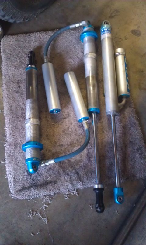 1992 Ford Ranger - Several shock absorbers are displayed on a rug, some with attached hoses.
