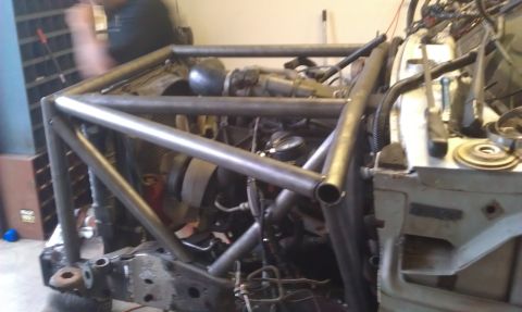 1992 Ford Ranger - Custom roll cage fabrication in progress within a truck's engine compartment.