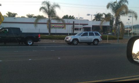 1992 Ford Ranger - Two vehicles are parked outside a business with a sign that reads 'Move' and 'Toyota Truck Center'.