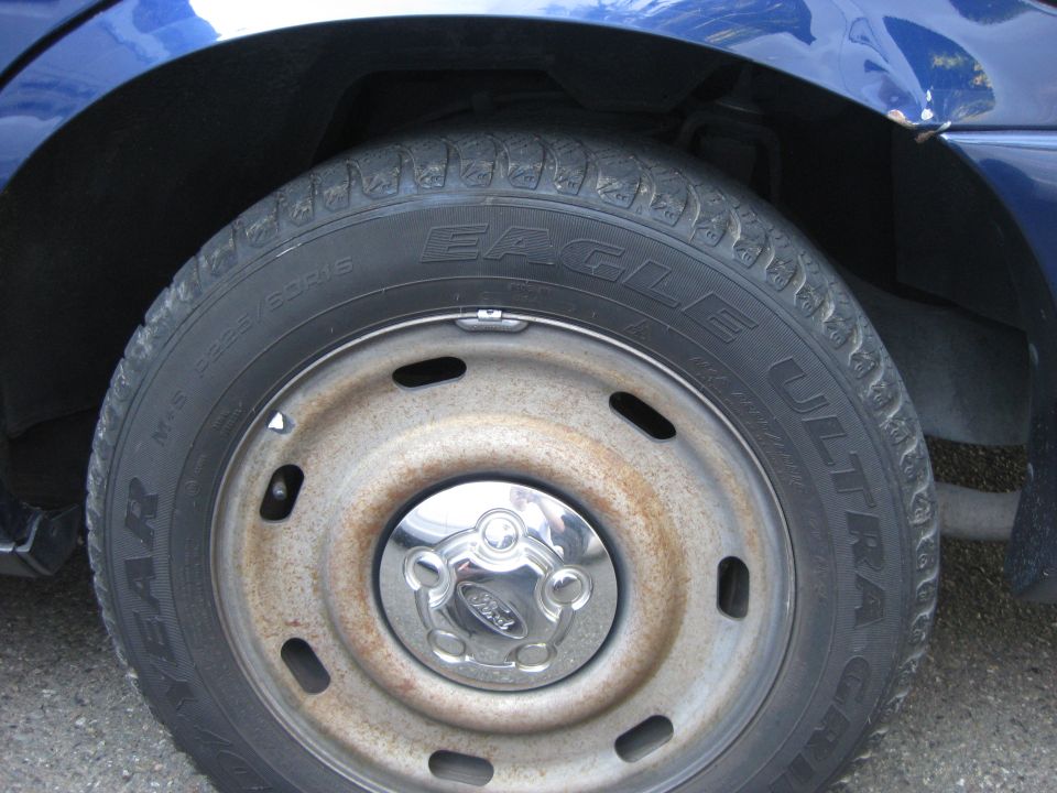 Blue 2003 Ford Crown Victoria wheel with Eagle Ultra tires and Ford center cap