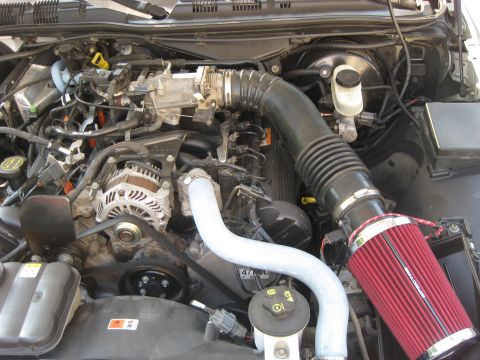 2003 Ford Crown Victoria - Engine bay of a Ford vehicle, likely a Crown Victoria, with an aftermarket cold air intake system installed.