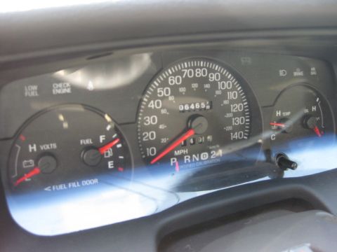 2003 Ford Crown Victoria - Dashboard gauges of a 2003 Ford Crown Victoria show 64,65 miles and fuel level.