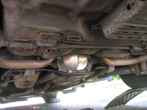 2003 Ford Crown Victoria - The underside of a vehicle is shown, focusing on the rear differential and exhaust components.