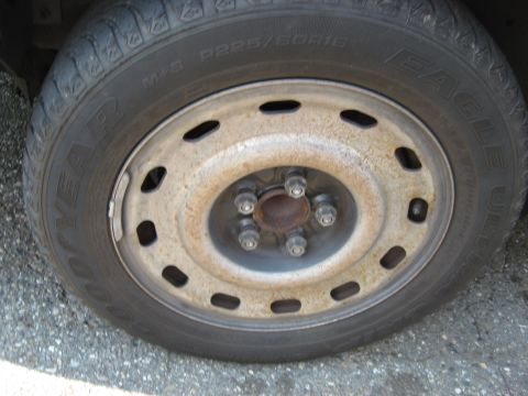 2003 Ford Crown Victoria - A close-up view of a Goodyear Eagle tire mounted on a steel wheel, showing the tire size P225/60R16.