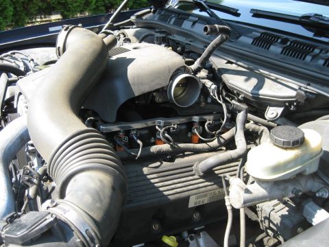 2003 Ford Crown Victoria - Engine bay of a 2003 Ford Crown Victoria, detailing the air intake system and engine components.