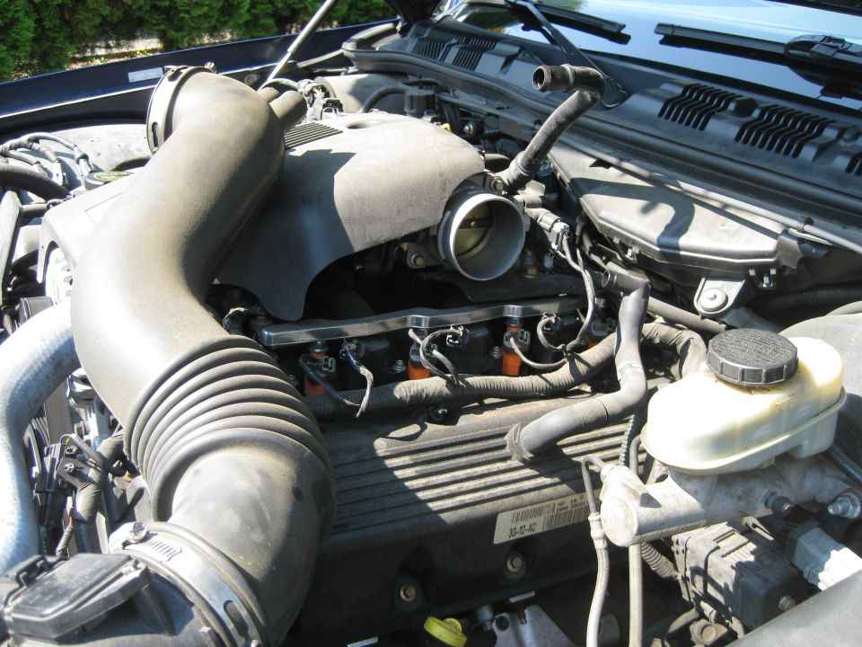 2003 Ford Crown Victoria engine bay showing air intake, throttle body, and fuel injectors