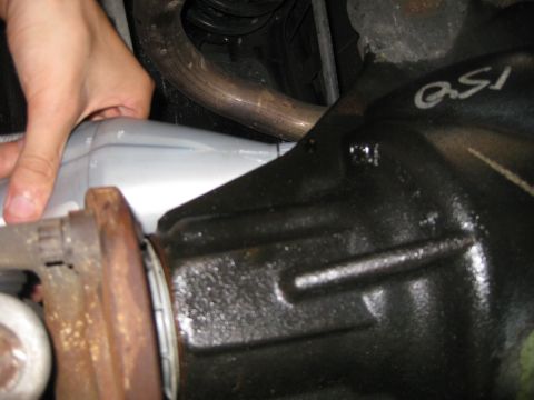 2003 Ford Crown Victoria - Close-up view of a vehicle's rear differential and exhaust pipe, with 'QSI' visible on the differential housing.