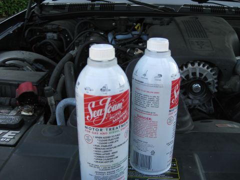 2003 Ford Crown Victoria - Engine bay of a 2003 Ford Crown Victoria, two cans of Sea Foam motor treatment.