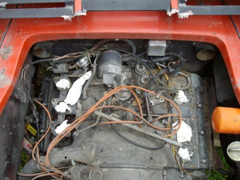 2000 Ford E350 - Engine bay view showing various components and wiring, with an orange oil filter visible on the right.
