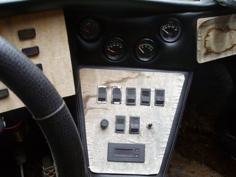 2000 Ford E350 - The dashboard features multiple gauges and a bank of switches, along with a digital readout.