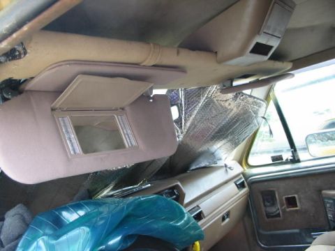1986 Ford Bronco - Interior view of a 1986 Ford Bronco, showing the dashboard, visor, and sunshade.