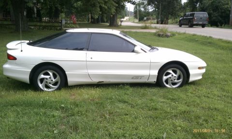 1994 Ford Probe - Side profile of a white Ford Probe GT with tinted windows and a rear spoiler.