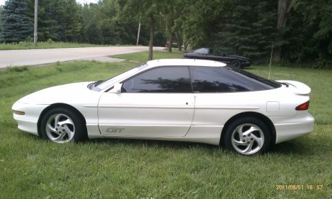 1994 Ford Probe - A white 1994 Ford Probe GT is parked on a grassy lawn with a second car visible in the background.