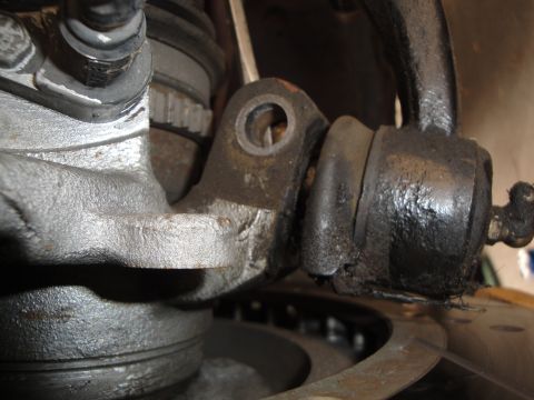 1995 Ford Taurus - Worn suspension bushing and associated metal components shown in a close-up view.