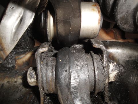 1995 Ford Taurus - Close-up of heavily greased and worn suspension bushings.