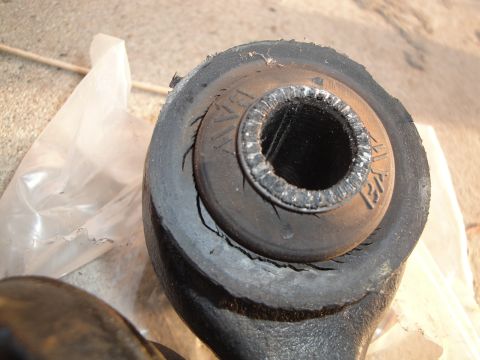 1995 Ford Taurus - Worn rubber bushing with 'BMW' text visible, indicating it's a BMW part.