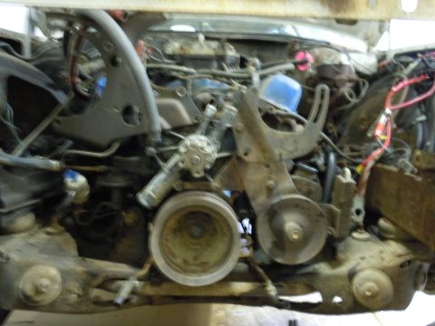 2001 Ford Crown Victoria - Close-up view of a disassembled engine bay with various mechanical parts visible.