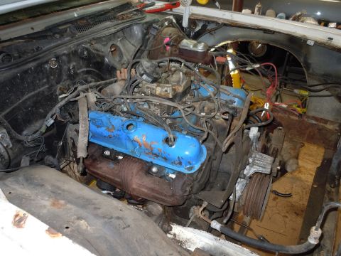 2001 Ford Crown Victoria - The engine bay of a vehicle, showing a V8 engine with blue valve covers and extensive wiring.