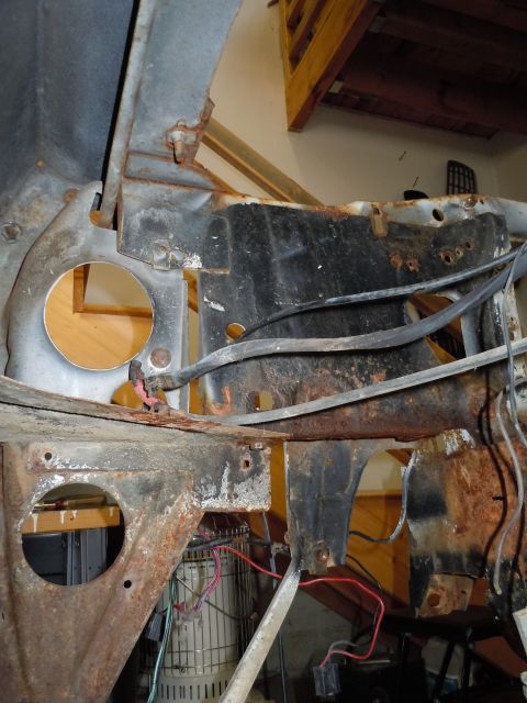2001 Ford Crown Victoria - This image shows the heavily rusted frame and engine bay of a vehicle, with various wires and components visible.